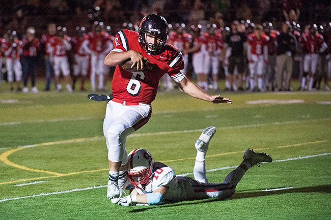 Marcus Larson/News-Register##
McMinnville QB Sam DuPuis runs for McMinnville s third touchdown, closing the score to 33-21 in the Grizzlies  game against South Salem. McMinnville lost the game 39-37.