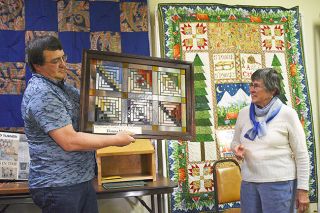 Submitted photo##
As Donna Hulett receives her honors, her son, Pat, holds up the stained
glass piece by Ralph Kraft that serves as her cultural asset award. Her
name also is on a plaque in Sheridan for two years. Submitted photo##
As Donna Hulett receives her honors, her son, Pat, holds up the stained
glass piece by Ralph Kraft that serves as her cultural asset award. Her
name also is on a plaque in Sheridan for two years.