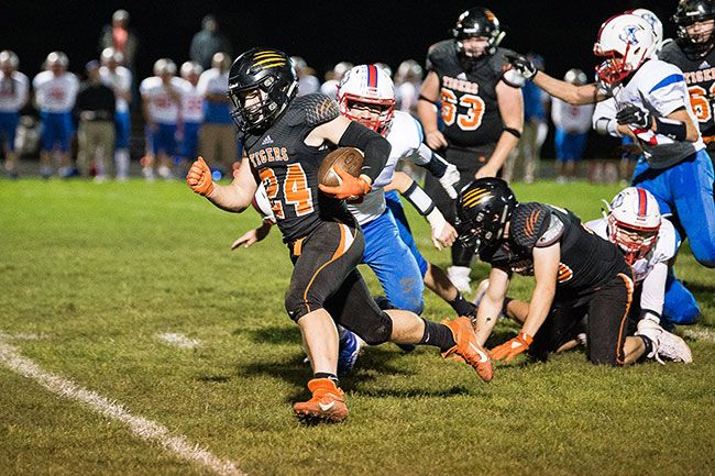 Marcus Larson/News-Register##
Yamhill-Carlton running back Jacob Preston powers through the Madras defense during Friday s league contest, which the Tigers won 27-7.