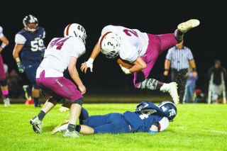 Marcus Larson/News-Register##
Sheridan’s Josh McCallister (84) upends the Pirates’ Zach Russell (2) for a loss in the backfield. Russell ran for 77 yards and four scores.