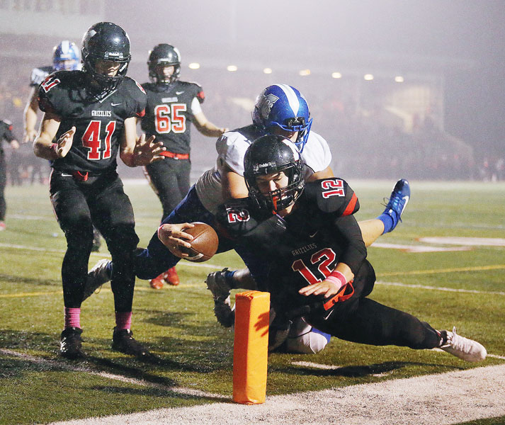 Rockne Roll/News-Register##
McMinnville quarterback Wyatt Smith (12) dives for the pylon to score the first touchdown of the game for the Grizzlies in the game against the McNary Celtics Friday.