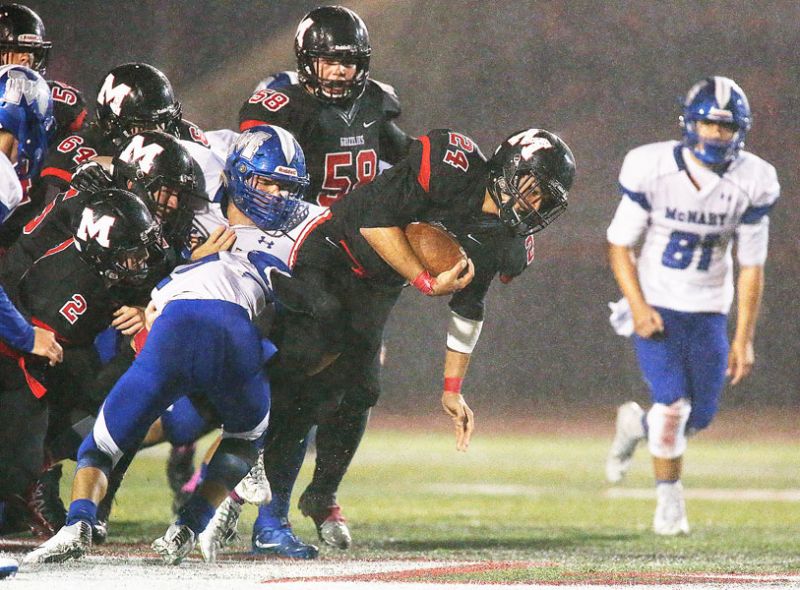 Rockne Roll/News-Register##
McMinnville s Cedric Agcaoili-Ostrom (24) fights for an extra yard in the Grizzlies  game against the Celtics at Wortman Stadium on Friday, Oct. 7.
