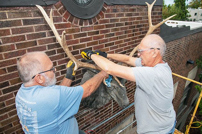 News-Register file photo## Bill Bryan of McMinnville, left, and Jim Jackot of Sheridan install new antlers in 2022 on the elk over entrance of Creekside Church, formerly the Elks Temple.