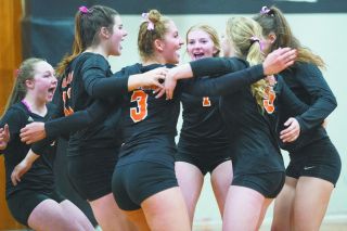 Marcus Larson/News-Register##
Y-C players celebrate a point during their Tuesday victory over Newport.