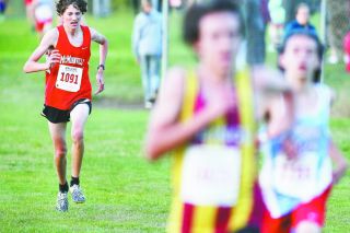 Rockne Roll/News-Register##
David Chupp (1091) chases down two runners at the finish of the boys’ varsity race Wednesday at Joe Dancer Park. He finished sixth overall.