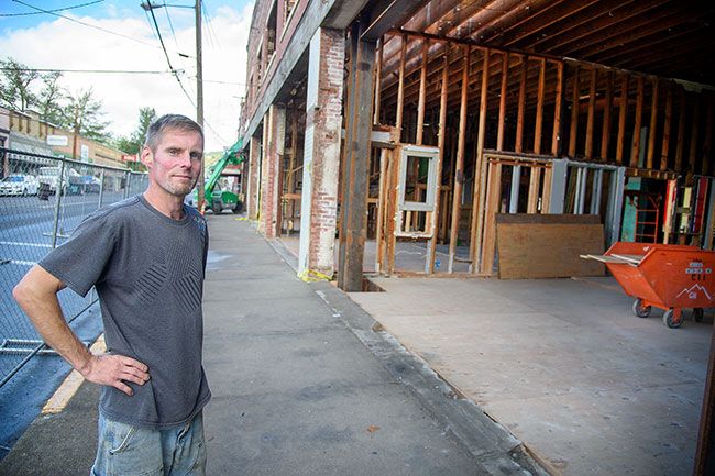 Rusty Rae/News-Register##Neil Livermore, a sub-contractor on the renovation project, stands in front of the historic building on Bridge Street in downtown Sheridan. The building, which dates back to the late 1800s, will house shops in the bottom floor and apartments on the second story.