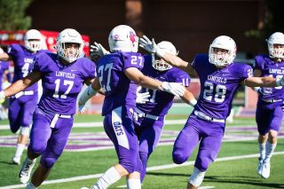 Marcus Larson/News-Register##
Linfield’s Keegan Weiss (27) is mobbed by his teammates after his 91-yard kickoff return touchdown against Lewis & Clark last Saturday at Maxwell Field. Marcus Larson/News-Register##
Linfield’s Keegan Weiss (27) is mobbed by his teammates after his 91-yard kickoff return touchdown against Lewis & Clark last Saturday at Maxwell Field.