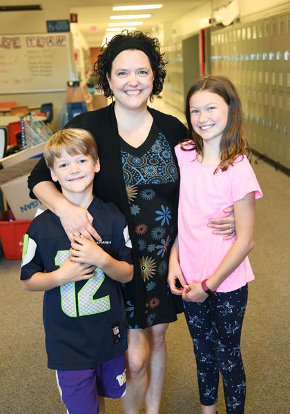 Rusty Rae/News-Register##Fleckenstein with her children, Charlie and Carolyn. She frequently volunteers in their classrooms at Memorial Elementary School.