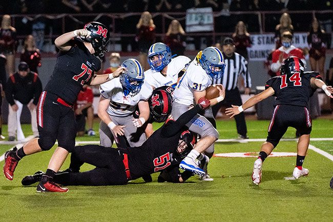 Marcus Larson/News-Register##
Jesse Jones-Nguyen attempts to tackle a Newberg ballcarrier during Friday s homecoming contest.