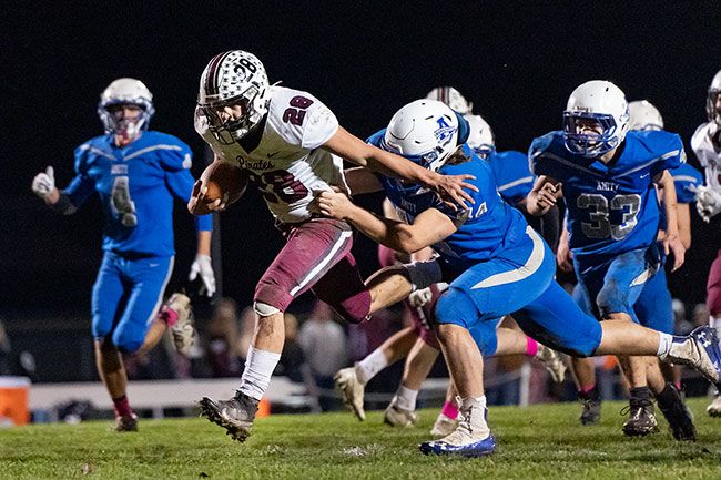 Marcus Larson/News-Register##
Dayton running back Nate Arce breaks free of a tackle by Amity s Wyett Yocum to score a 19-yard touchdown.