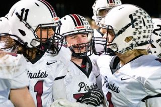 Marcus Larson/News-Register##
Dayton players Tony Cisneros, Parker Stephens and Kaiden Abell celebrate a big play on the field during the Pirates’ big rivalry game against Amity last Friday night.
