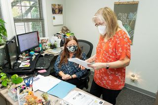 Marcus Larson/News-Register##McMinnville Area Chamber of Commerce President Gioia Goodrum talks with events director Rhonda Pope in the Chamber’s new offices.