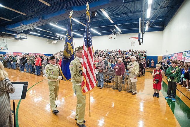 Marcus Larson / News-Register
The county Veterans Honor Guard retire the colors at Patton’s assembly. Music by Mac High’s symphonic choir also was featured, along with “Taps” played by Linfield band director Joan Paddock.