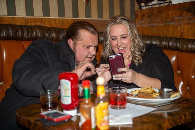 Rusty Rae/News-Register##McMinnville City Councilor Adam Garvin checks the initial results Tuesday night with his fiancée, Trish Williams, during a small election night gathering with friends at the Blue Moon.