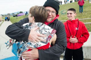 Marcus Larson/News-Register file photo##
McMinnville head cross country coach Vic Downs embraces his sophomore athlete, Zane Fodge, following the 2017 OSAA 6A State Cross Country Championships. Marcus Larson/News-Register file photo##
McMinnville head cross country coach Vic Downs embraces his sophomore athlete, Zane Fodge, following the 2017 OSAA 6A State Cross Country Championships.