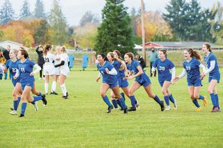 News-Register File Photo##The Amity girls soccer team rushes towards the net to celebrate after defeating Sisters in the state quarterfinals in a penalty shootout on Nov. 5.