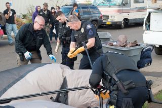 Rusty Rae/News-Register##McMinnville police Capt. Tim Symons, Officer Justin Brenner, Officer Robert Harmon and Officer Mike Maierhofer confiscate Kim Wood’s tent Wednesday on N.E. Dustin Court. Rusty Rae/News-Register##McMinnville police Capt. Tim Symons, Officer Justin Brenner, Officer Robert Harmon and Officer Mike Maierhofer confiscate Kim Wood’s tent Wednesday on N.E. Dustin Court.