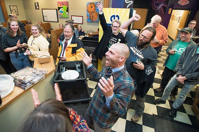 Marcus Larson/News-Register##County Commissioner candidate Casey Kulla celebrates with friends, family and supporters at 3rd Street Pizza in McMinnville following release of initial election results gave him a  sizable lead over incumbent Stan Primozich.