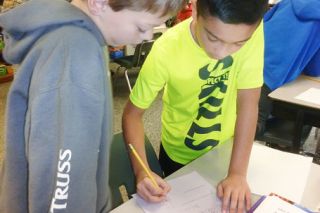 Starla Pointer  / News-Register
##Cole Lambert and Amos Rodriguez work together to solve a word problem and explain how they found the answer.