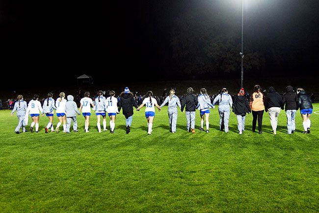 Rusty Rae/News-Register##The Amity girls walk hand-in-hand across the pitch to their supporters, who cheered for them throughout the season, after their loss in the state semifinals.