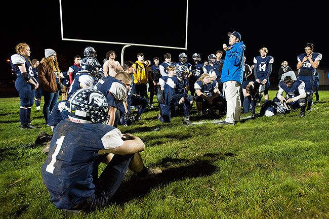 Marcus Larson/News-Register##
Sheridan players are consoled by head coach Jacob Peterson after their 27-6 loss to Kennedy.