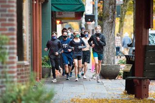 Marcus Larson/News-Register##Members of the McMinnville High School cross country team jog on Third Street wearing masks last month. School board members praised the students and their coaches for taking safety precautions as they return to practices. Other fall sports teams and those from winter and spring also are practicing skills and teamwork one or two afternoons a week. Marcus Larson/News-Register##Members of the McMinnville High School cross country team jog on Third Street wearing masks last month. School board members praised the students and their coaches for taking safety precautions as they return to practices. Other fall sports teams and those from winter and spring also are practicing skills and teamwork one or two afternoons a week.