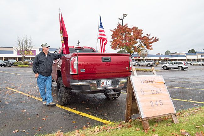 Marcus Larson/News-Register ##
With flags and a handmade sign, veteran Chris Parks observes the 245th birthday of the Marine Corps on Tuesday. Parks, who served 6 1/2 years in the Marines, also cruised with his flags on Veterans Day and Election Day.