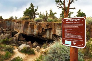 Image: Greg Shine/BLM##The entrance to one of the Redmond Caves, formed when a large lava tube collapsed.
