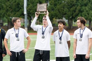 Marcus Larson/News-Register##Dayton’s Tyler Spink holds up the OSAA 3A/2A/1A boys soccer second place trophy after their 8-1 loss in the state final game on Saturday. Spink was one of five seniors who led the team to the program’s first championship game appearance.