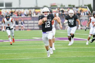 Katie Phillips photo##Linfield quarterback Wyatt Smith sprints past the Pioneer defenders for a 35-yard touchdown run in the second quarter of Saturday’s game.