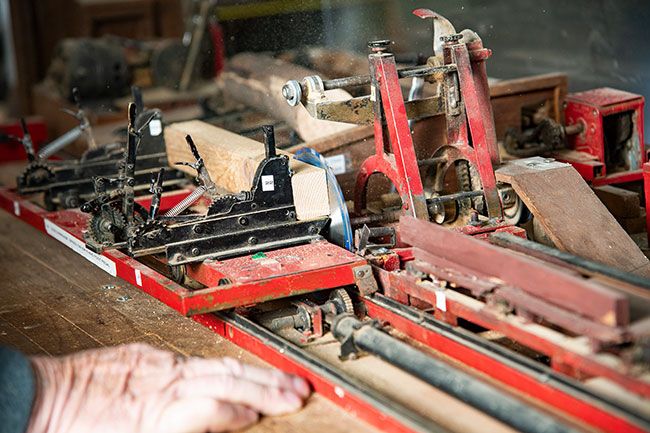 Rusty Rae/News-Register##A detail of the tiny mill shows how it saws a 2-by-2 piece of wood to make ¼-inch thick boards. It works just like a full-size mill.