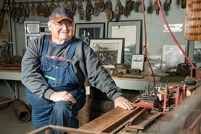 Rusty Rae/News-Register##Gary Brooks shows off the working miniature sawmill, which he reconstructed over 18 months at the Yamhill Valley Heritage Center. He also volunteers in the museum’s real sawmill. Both turn trees into lumber, the real mill for building projects and the tiny mill for rulers.