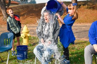 Rusty Rae/News-Register##
Fifth grade teacher Ryan Wells shows his pleasure in getting doused with a bucket of ice water. Doing the honors is fifth grader Sophie Bingman.
Cooper Lamb cheers on the pourers.