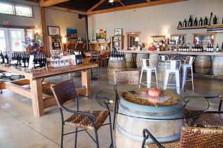 Rusty Rae/News-Register##Guests have a choice of seating as they sample Coelho wines in the winery’s tasting room in Amity. It features natural lighting, a fireplace and a piano, along with many wine barrels.