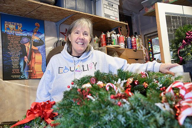 Rusty Rae/News-Register##Janet Zuelke uses fir, cones and other natural materials to make Christmas wreaths in her Carlton workshop. She grew up helping her mother make wreaths and continued the tradition when her own kids were young.