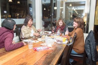 Rusty Rae/News-Register ##
Enjoying a glass of wine together Tuesday at Willamette Valley Vineyards’ downtown McMinnville tasting room are Tami VanSlyke, Ann Lewis, Karen Gormanand Shirley Bahrman, all of McMinnville. A statewide “freeze” took effect Wednesday, closing restaurants, bars and tasting rooms to indoor dining and drinking.