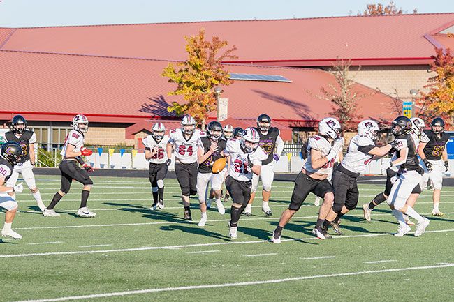 Rachel Thompson/News-Register##Tristan McGann (21) breaks free for a 54-yard run in the third quarter of Dayton’s 42-20 loss to Cascade Christian.