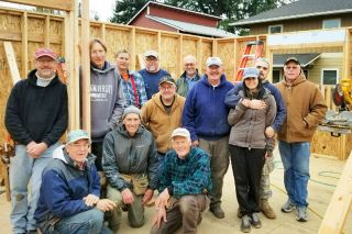 Submitted photo##Doug Cruikshank (kneeling in front center) poses with other members of Habitat for Humanity’s Veterans Build crew and new homeowners Ed and Elizabeth Floyd (hugging toward right). Ed is a veteran of the U.S. Army.