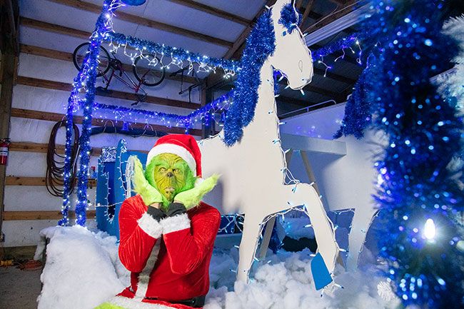 Rusty Rae/News-Register##The Grinch (Ben Blanco) prepares to ride in Friday afternoon s Santa Parade, which will
roll through downtown McMinnville starting at 4:30 p.m. Friday, Nov. 26. The Grinch and
his little dog, too, will be joined by real estate agents from Coldwell Banker of McMinnville
and Newberg, who built the float using the company s blue and white colors, according to
Tammy Cooley, one of the Coldwell employees.  We like to do it for the community,  she
said, noting that agents will be handing out 3,000 candy canes, as well. More than two
dozen other floats, marching groups and bands will take part in the parade, which marks the
arrival of the Christmas season and Santa s first visit to McMinnville this year.