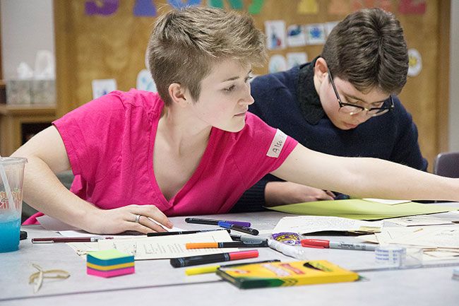 Helen Lee/News-Register##Idhunn Stiller and Zane Downs work on arts and crafts during the Nov. 18 LGBTQ support group meeting.