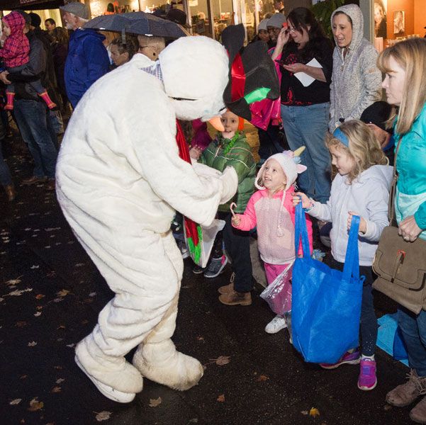 Marcus Larson/News-Register##
During the Christmas parade, three-year-old Olivia Lehman, dressed in a unicorn hat, receives a candy cane from Frosty the Snowman.