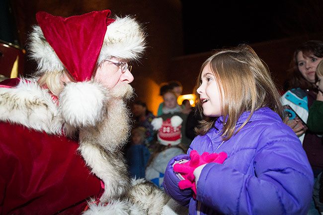 Marcus Larson/News-Register##
Olivia Rosenberg visits with Santa telling him she wants a  L.O.L. Surprise!  for Christmas.