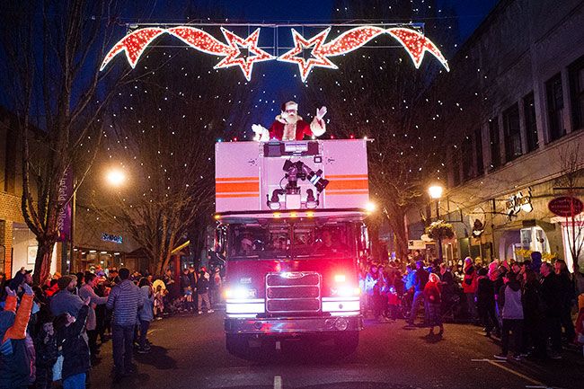 Marcus Larson / News-Register##Santa arrives Friday afternoon on a fire truck, marking the start of the Christmas season.