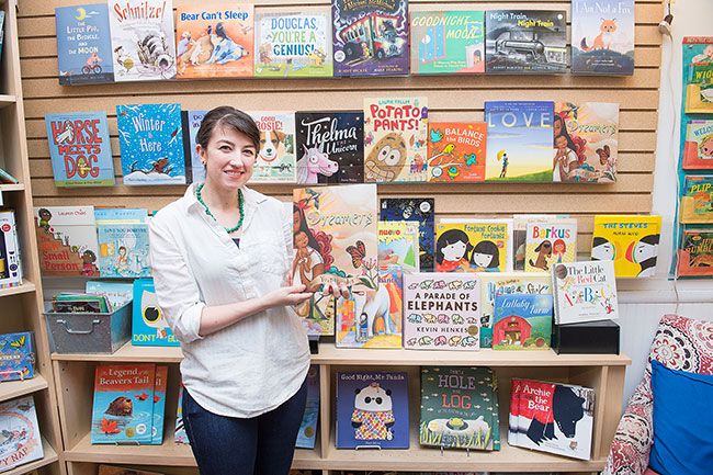 Rusty Rae/News-Register##Third Street Books employee stands in front of a large display of kids books in the store.