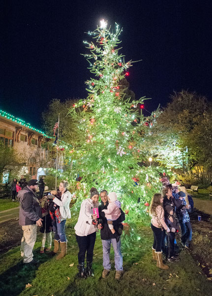 Marcus Larson/News-Register##
Moments after the McMinnville town Christmas tree is lit, many families crowd around, taking selfies.