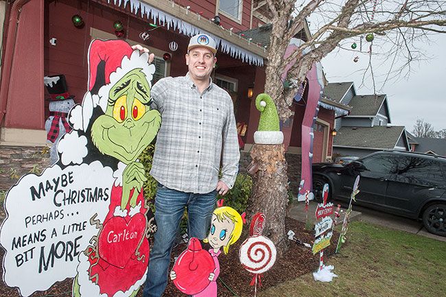 Rusty Rae/News-Register##Casey Livingston, the Grinch and Cindy Lou Who welcome holiday visitors as they drive past the Livingston house in Carlton. Livingston cut out and painted the characters from his favorite Dr. Seuss story.