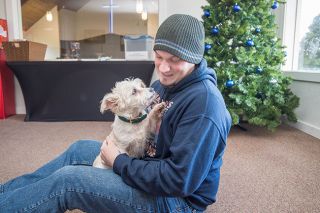 Marcus Larson/News-Register ##
Minister Sam Aldridge plays with his dog, Abigail, who often accompanies him to work at the Willamina Free Methodist Church. She will receive Christmas suprises later this month.