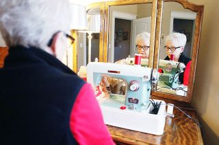 Rockne Roll/News-Register##Connie Foster sews a garland for her outdoor Christmas tree, which will be on display during the Soroptimists’ annual holiday home tour. She also made a tablecloth and quilts for the event.