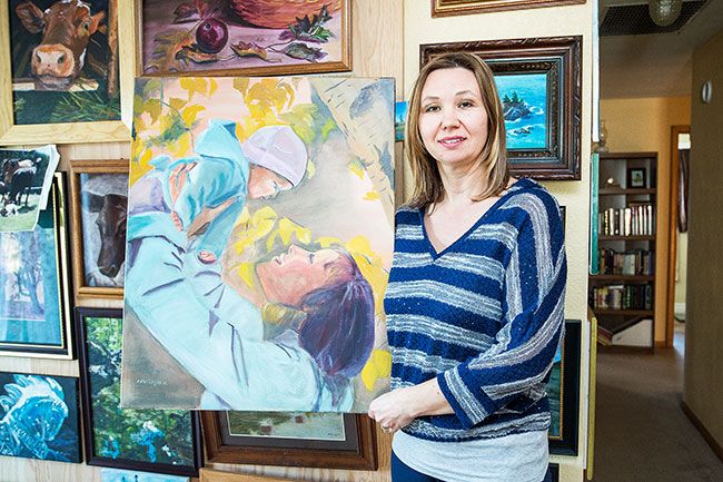 Marcus Larson/News-Register ## Natalia Novikoff shows off the favorite of her paintings, “Late Motherhood,” which depicts her cousin with her newborn. Novikoff has painted many scenes of her family and homeland since moving from Russia in 2010.