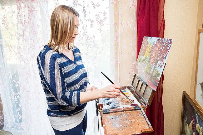 Marcus Larson/News-Register ## Artist Natalia Novikoff painting at her easel in her McMinnville home studio. She said she likes to paint fast and surprise herself with the results.